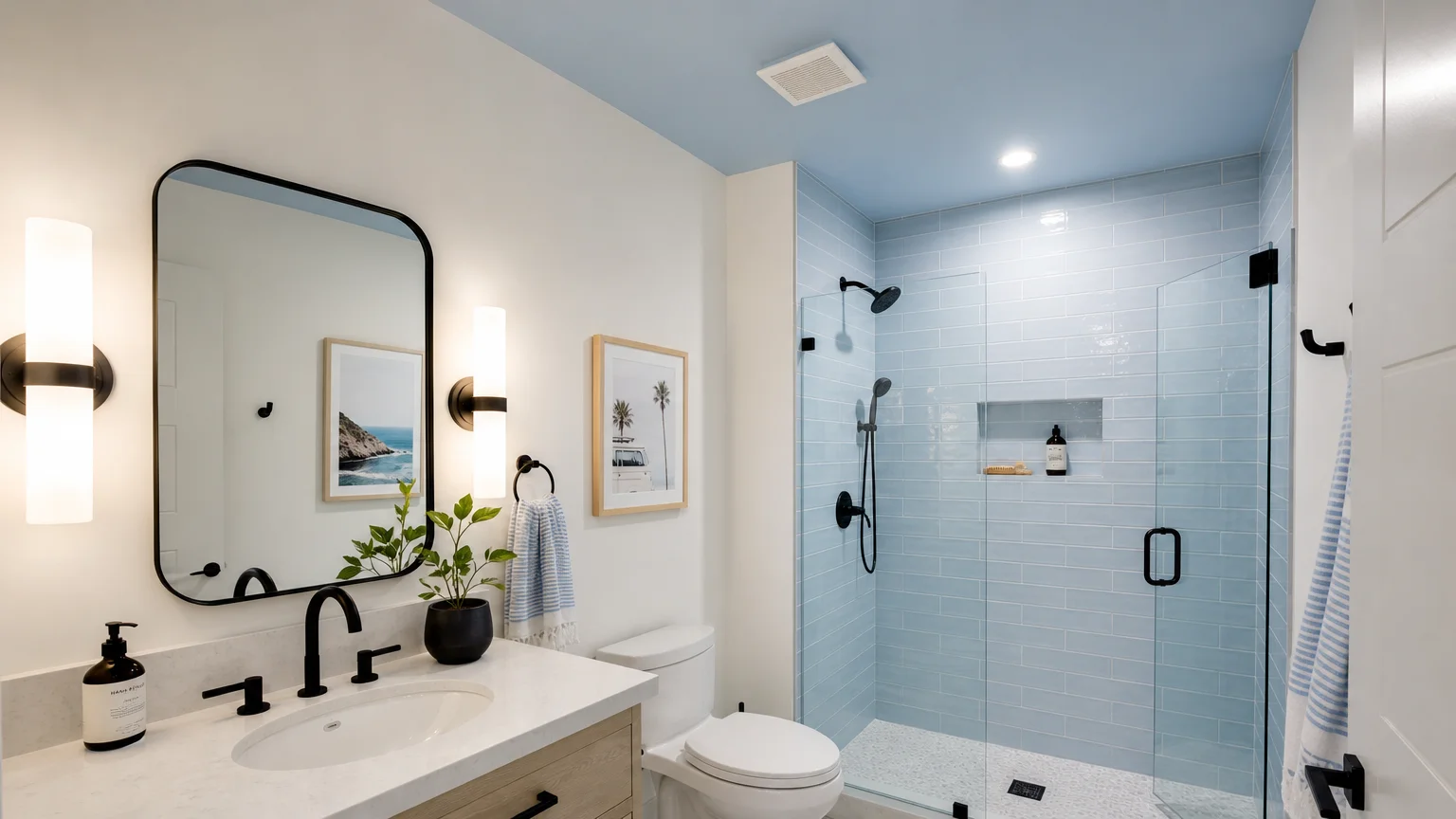 A modern bathroom corner with matte alabaster white walls, a pale sky-blue ceiling, and glossy sky-blue shower tiles.