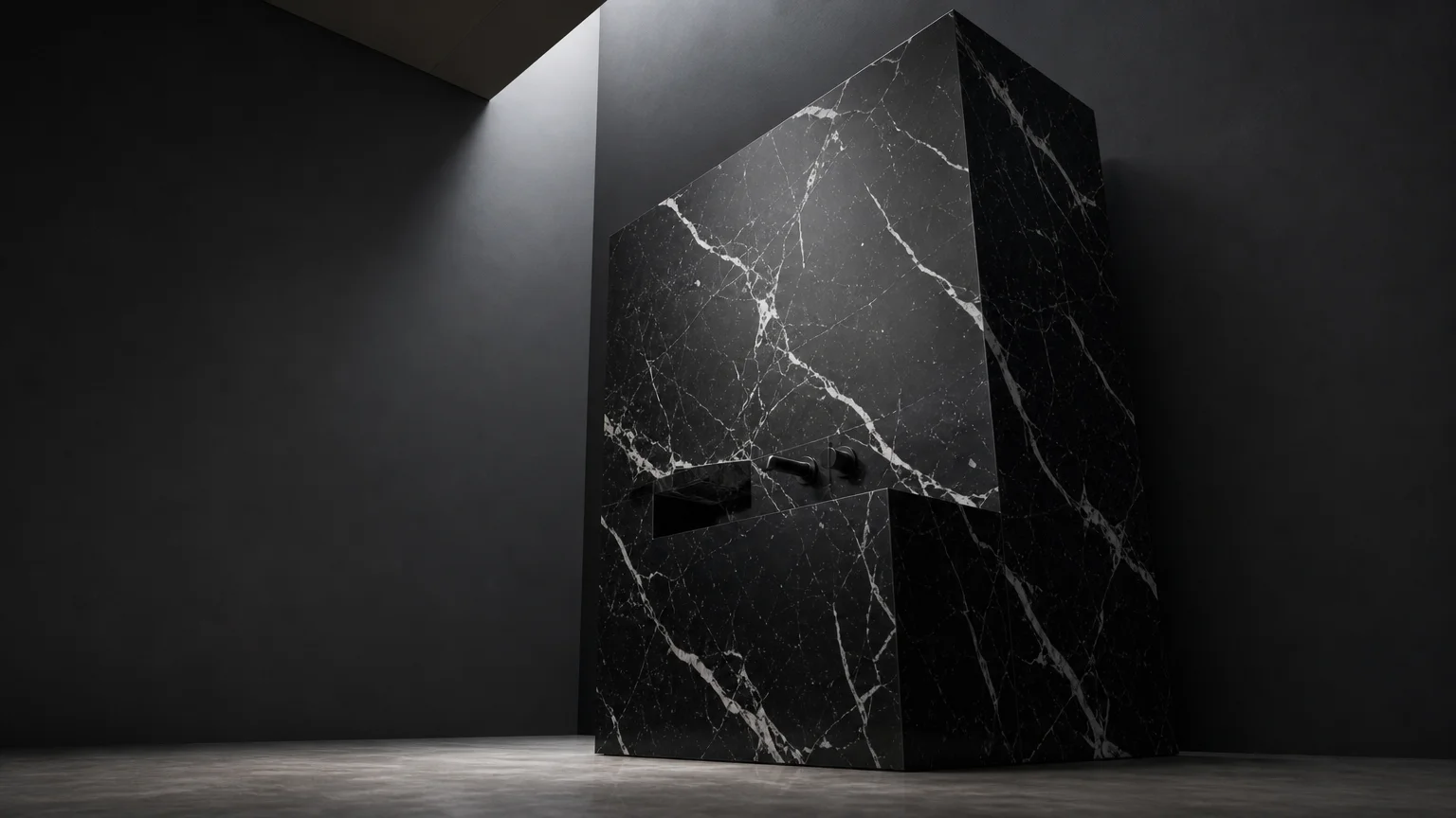 A solid monolithic black marble vanity block with white veining in a minimalist dark bathroom.
