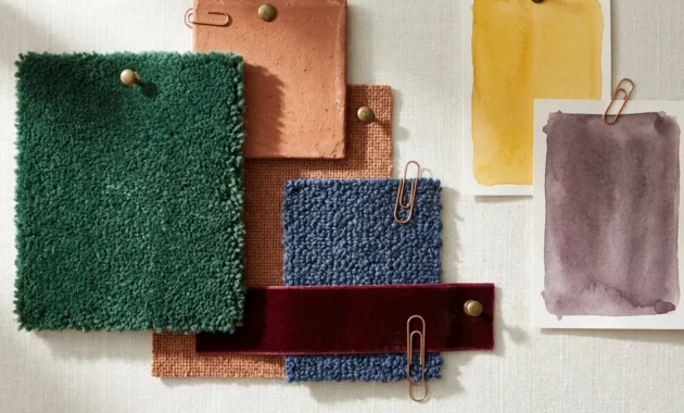 A tactile mood board collage of 2026 carpet trend swatches including emerald, terracotta, indigo, and burgundy wool fabrics.