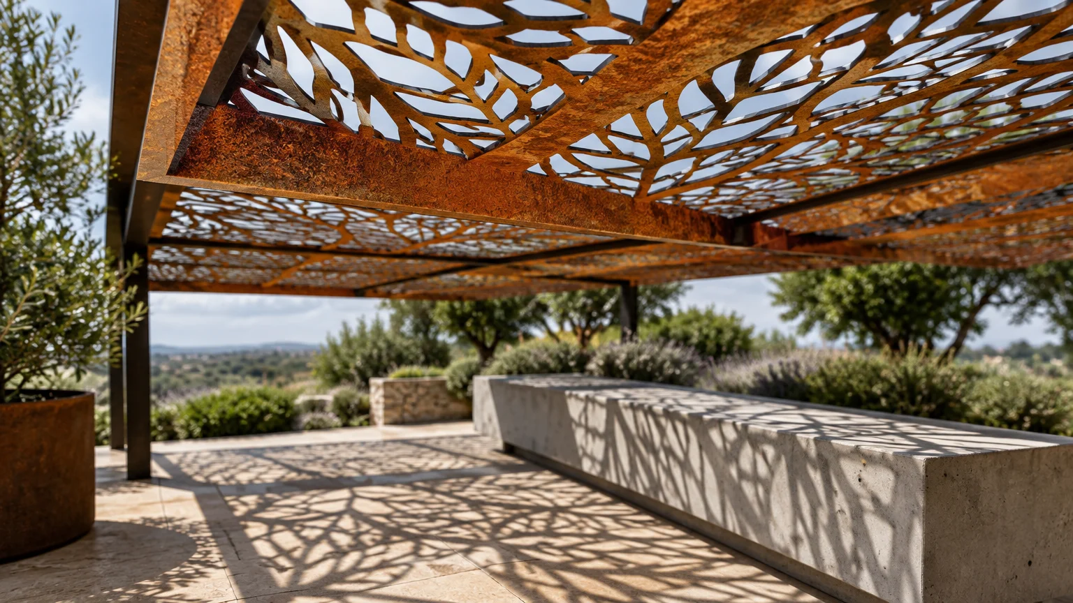 Laser-cut rusted metal pergola roof casting branch-like shadow patterns across a patio and concrete bench.